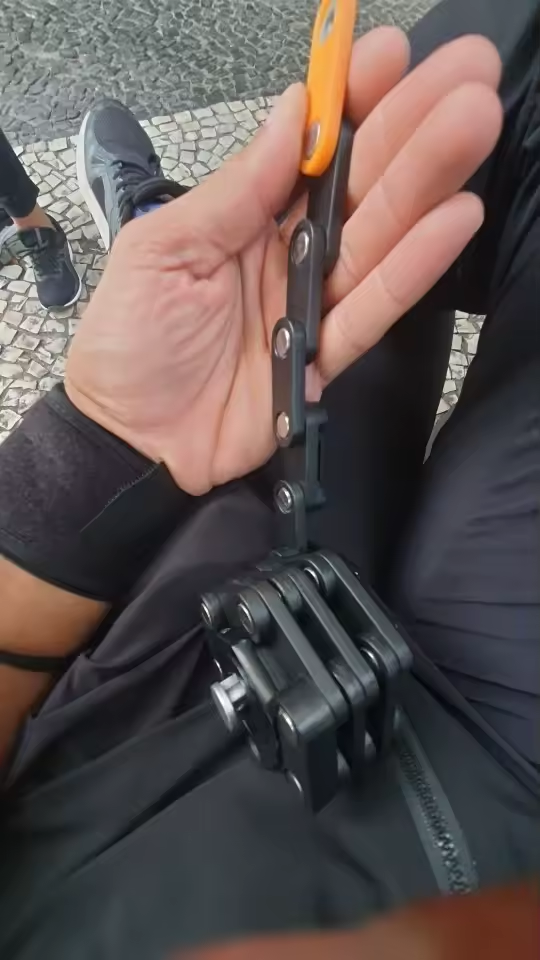 Folding lock partly unfolded, held in a hand